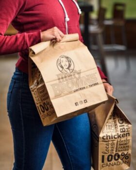 Woman holding a mary browns bag for takeout